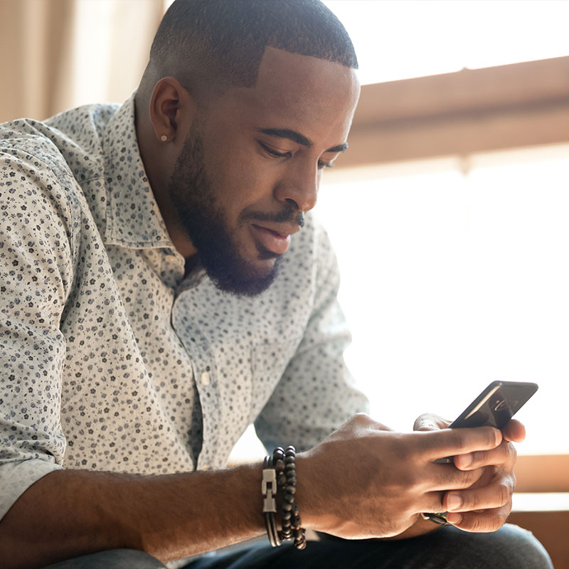 man ordering commissary with cell phone